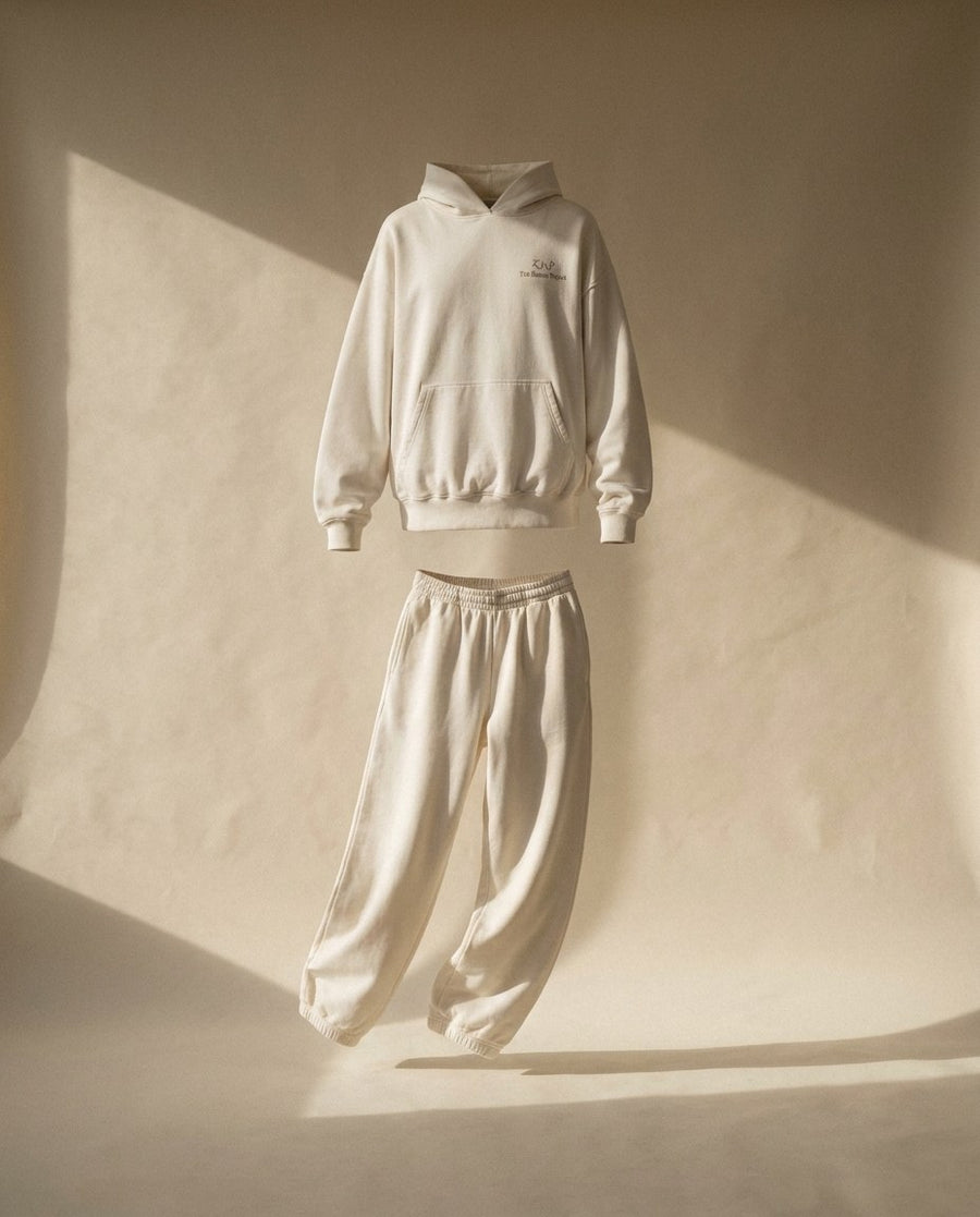 The In Progress Set: hoodie and wide-leg sweatpant floating in warm window light